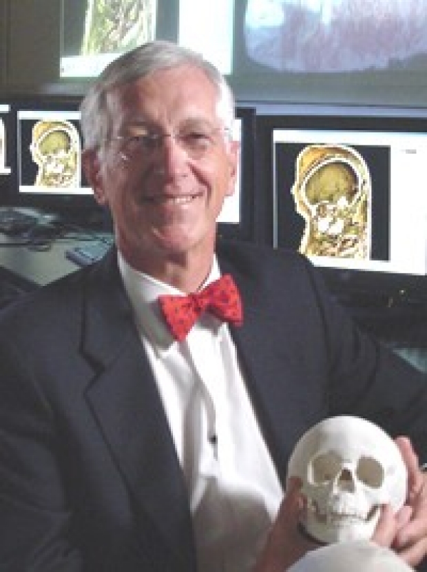 Image of Dr. Paul Brown holding a child mummy