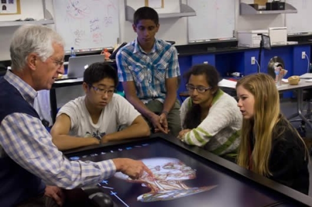 Dr. Brown, inventor of the Anatomage Table, teaches students around the table with patient data