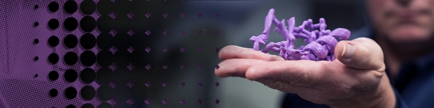 hand holding a purple 3D printed model