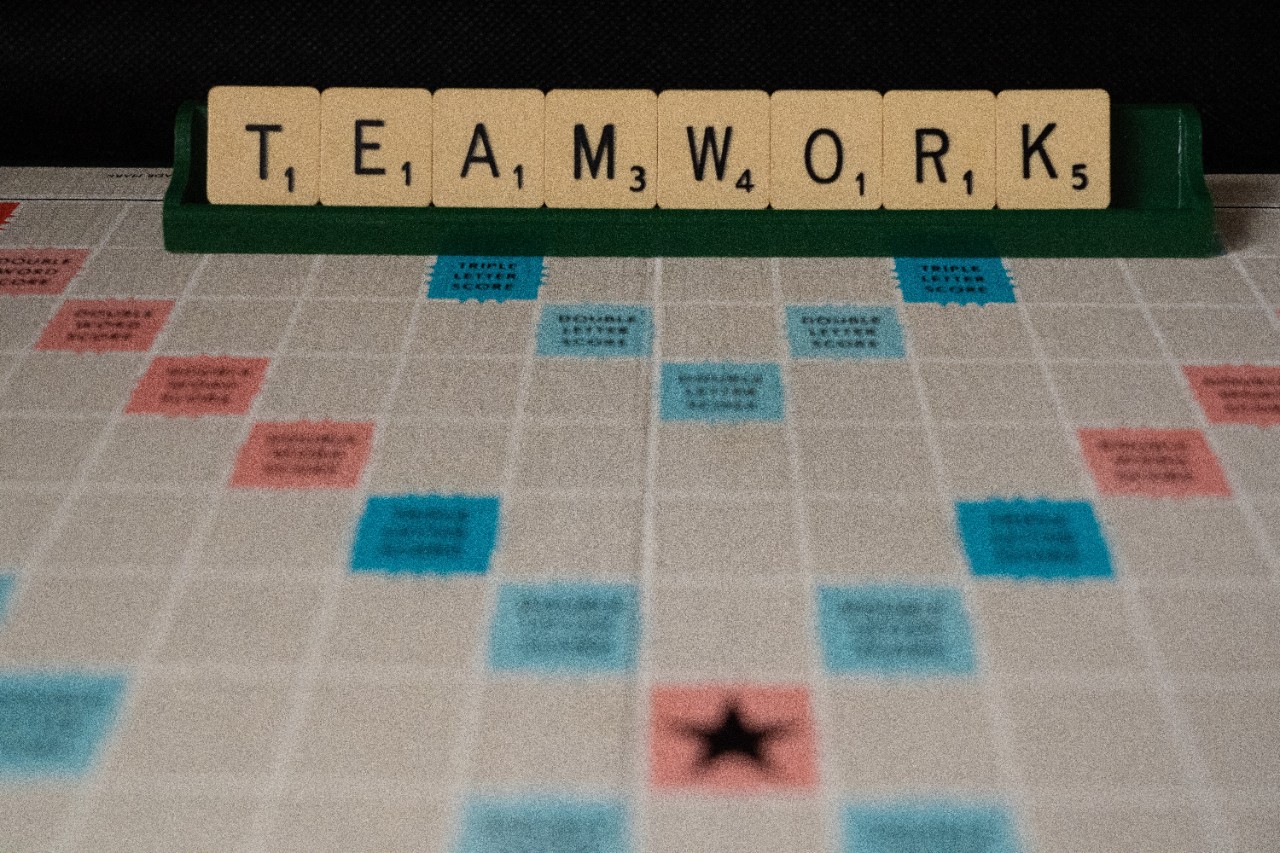 Scrabble board spelling out "teamwork"
