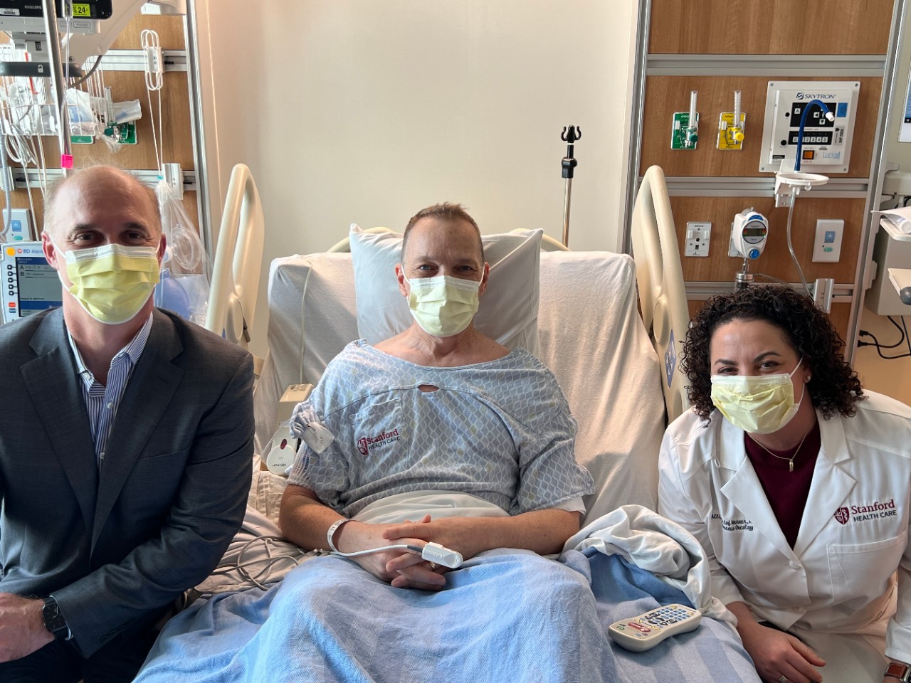 Two doctors and patient in a hospital room