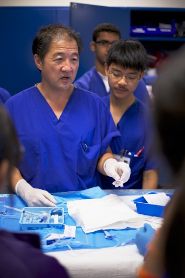Paul Chang teaching students in surgery lab