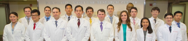 group picture of residents and Drs. Michael Fischbein and Joseph Woo all wearing lab coats