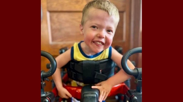 smiling little boy in wheelchair