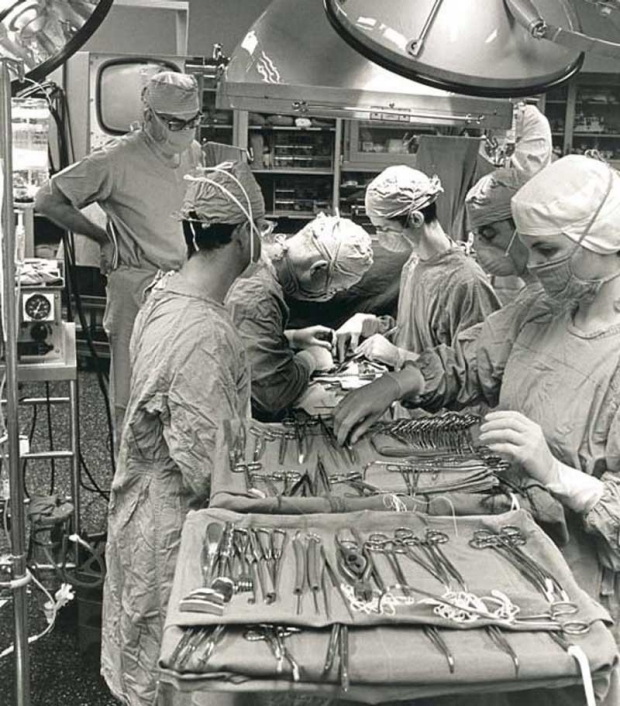 Drs. Norman Shumway (center left surgeon) and Edward Stinson (center right surgeon) in the operating room