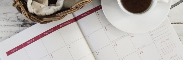 Image of desk calendar and cup of coffee from Debby Hudson/ Unsplash.com