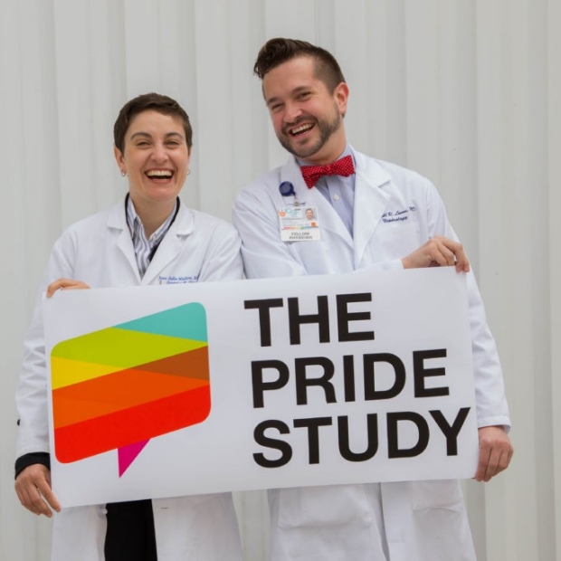 Juno Obedin-Maliver and Mitchell Lunn hold PRIDE Study sign, image from Stanford Scope Blog