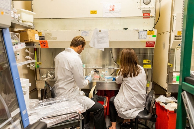 photo of two lab members in a lab
