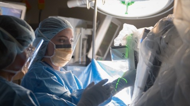 A general surgery resident assists on a robotic surgery