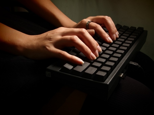hands typing on a laptop