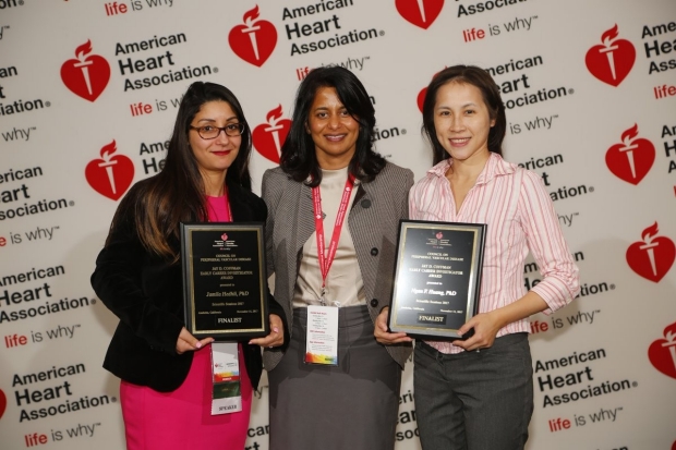 three women, two holding awards