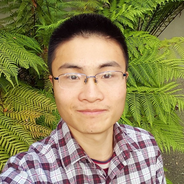 smiling headshot of Guang Yang