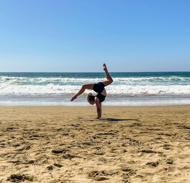 Sydney doing contortion on the beach.