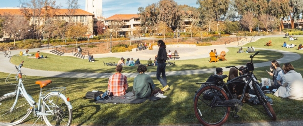 students and bikes in front of grassy area