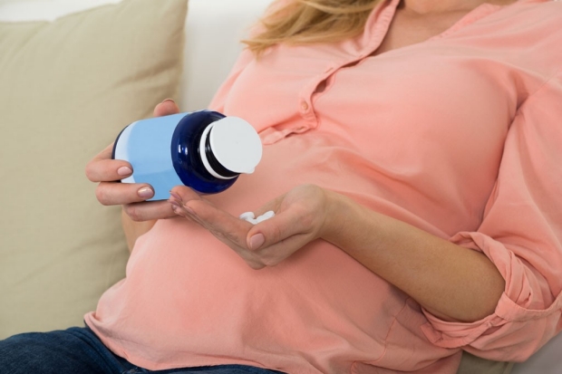 Pregnant woman taking supplements