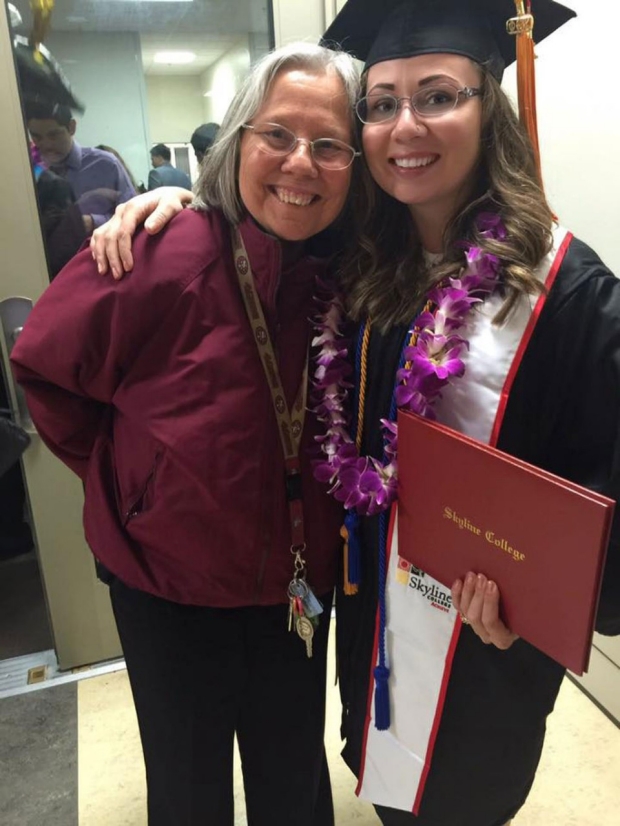 Woman in a graduation cap and gown hugging another woman