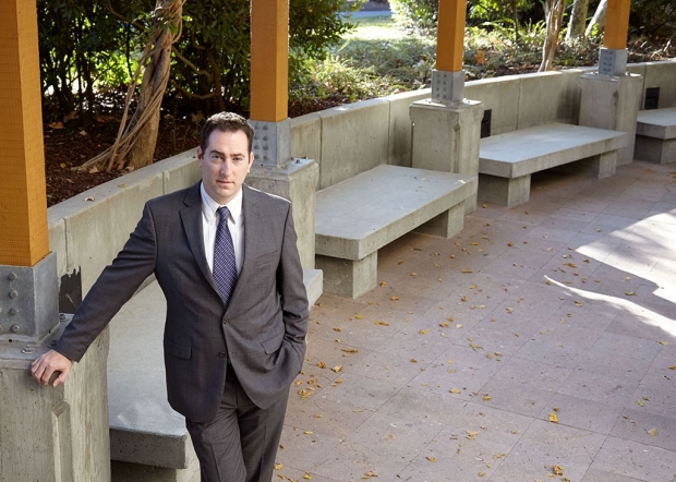 Man in a suit standing in an outdoor courtyard