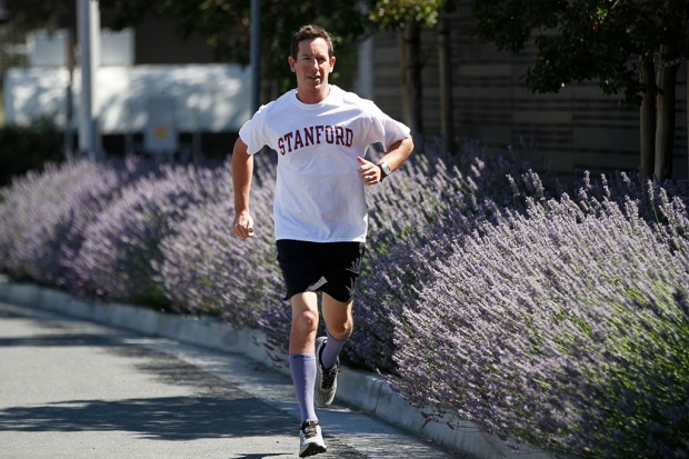 Man running outdoors in a Stanford T-shirt