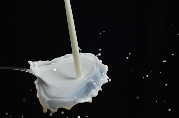 Milk splashing on a dark surface