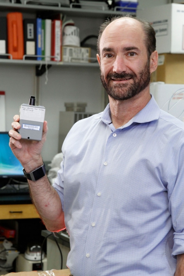 Michael Snyder holding an environmental monitor