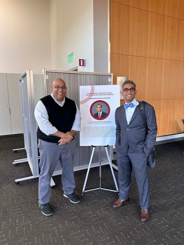 Dr. Nayak and Dr. Duvvuri standing in front of poster
