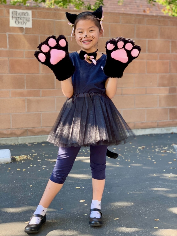 Annabelle dresses up as a cat on Halloween.