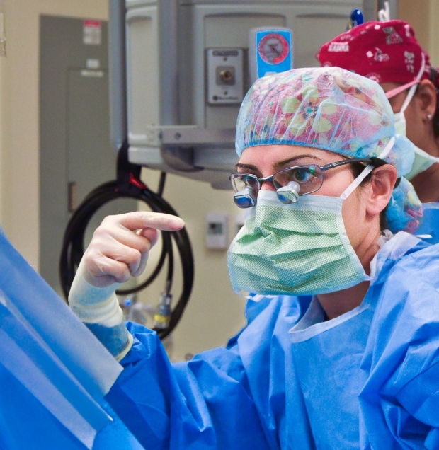 Dr. Kossler in surgery in her scrubs
