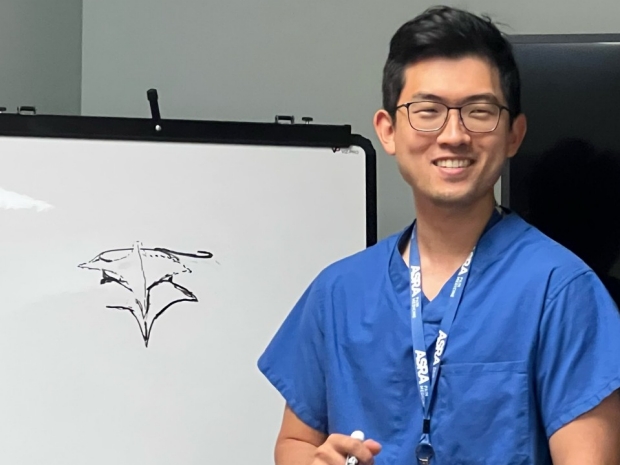 Dr Kim teaching epidurals in front of white board