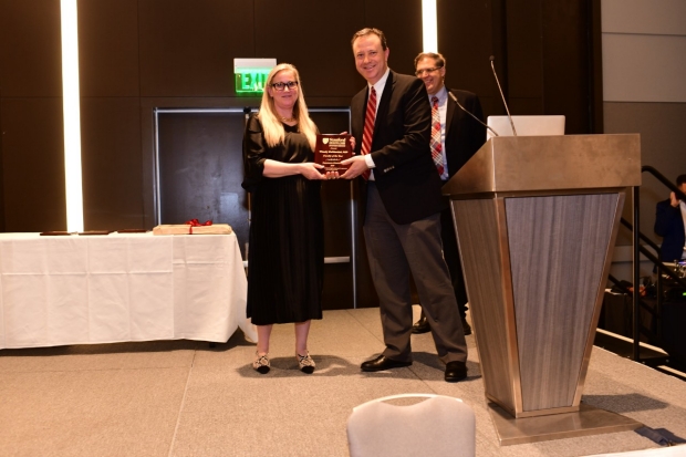 Photo of Wendy DeMartini receiving 2019 Faculty of the Year award from David Larson and Garry Gold