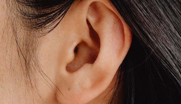 Women's ear with hair tucked behind it