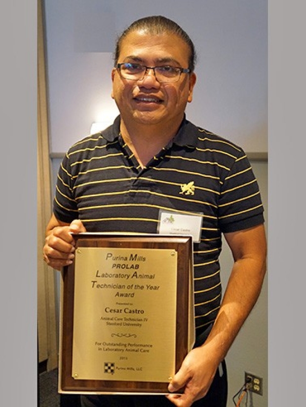 Cesar Castro holding award